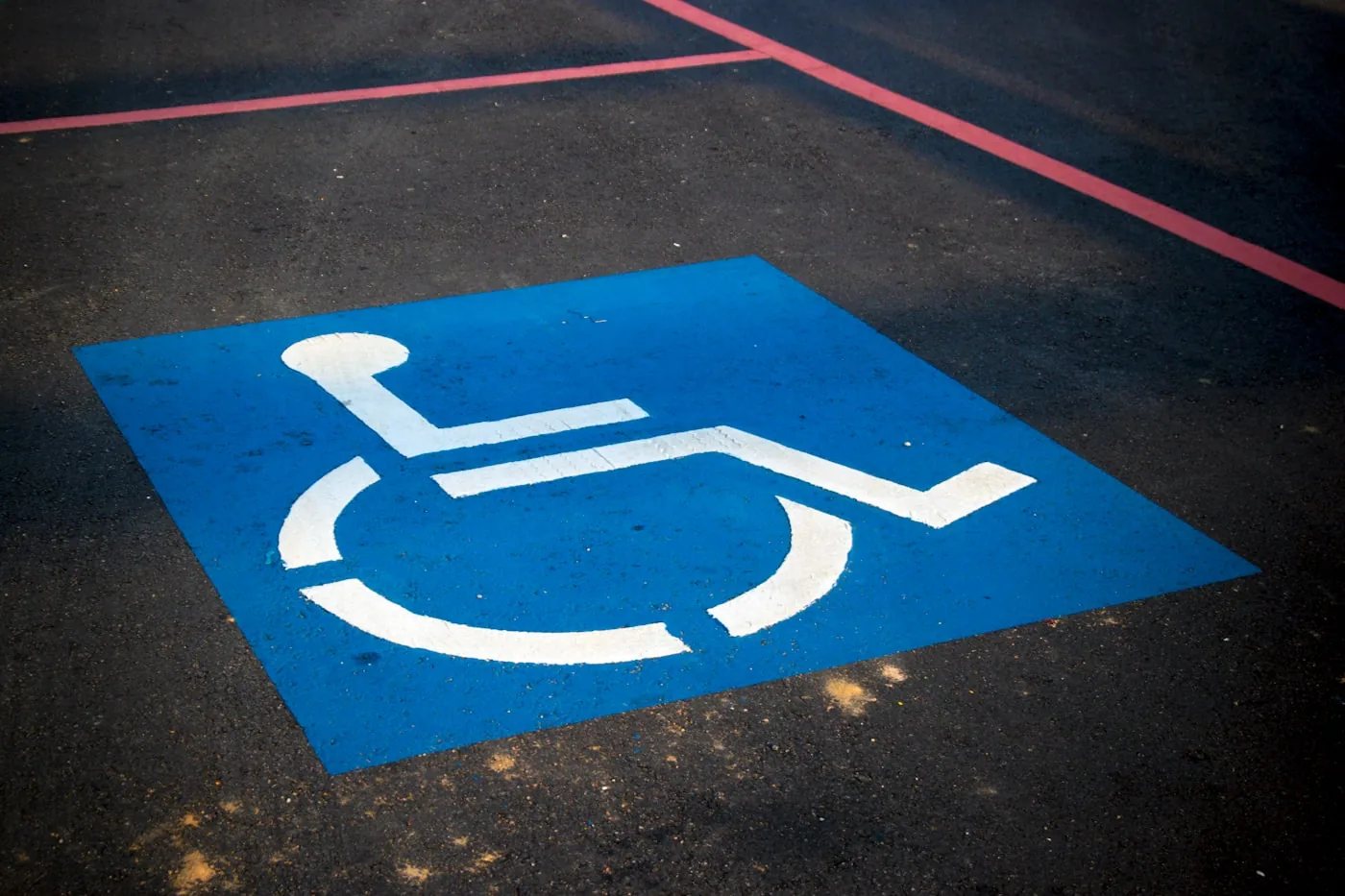 Accessible parking space symbol painted on pavement