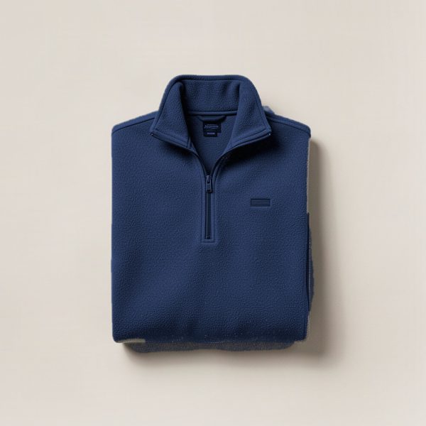 Birch Fleece Pullover in Navy — quarter-zip fleece pullover, folded on a light grey backdrop