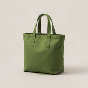 Birch Tote in Moss — canvas tote bag with two flat handles on a light grey backdrop