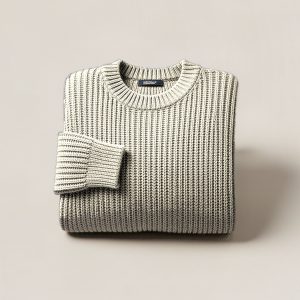 Birch Watch Sweater in Cream — chunky ribbed-knit crew-neck sweater, folded on a light grey backdrop