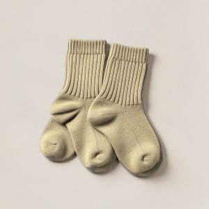 Birch Camp Sock in Sand — pair of thick ribbed camp socks on a light grey backdrop