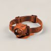 Cedar Headlamp in Rust — compact headlamp with a lens housing and an elastic headband on a light grey backdrop