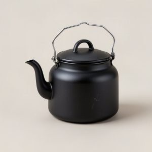 Cedar Kettle — matte black enamelled camp kettle with a spout and wire bail handle on a light grey backdrop