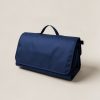 Cedar Picnic Blanket in Navy — water-resistant picnic blanket, folded with a carry handle on a light grey backdrop