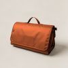 Cedar Picnic Blanket in Rust — water-resistant picnic blanket, folded with a carry handle on a light grey backdrop