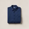 Driftwood Flannel Shirt in Navy — button-up flannel shirt, folded on a light grey backdrop