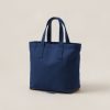 Driftwood Tote in Navy — canvas tote bag with two flat handles on a light grey backdrop