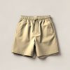 Driftwood Trail Short in Sand — lightweight trail shorts with an elastic drawcord waist, folded on a light grey backdrop