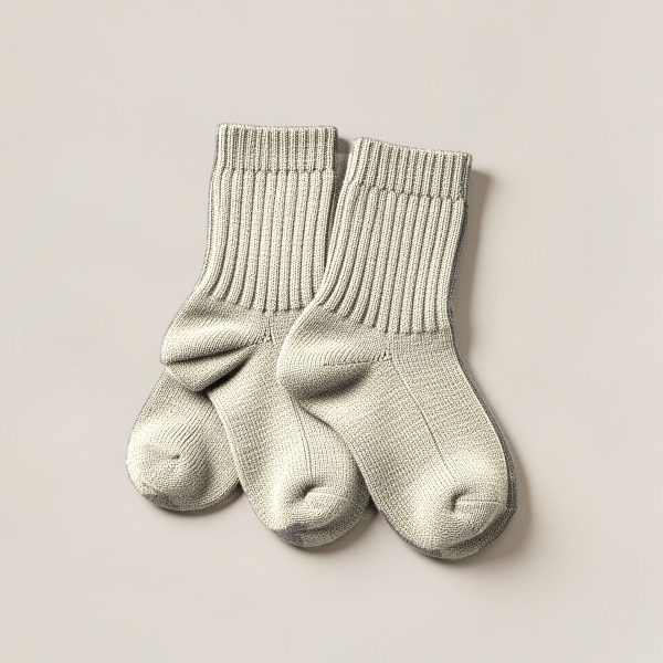 Ember Camp Sock in Cream — pair of thick ribbed camp socks on a light grey backdrop