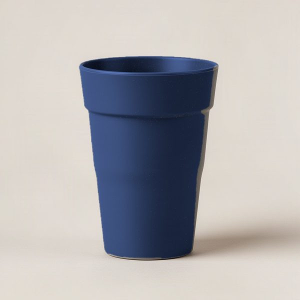 Ember Pint Cup in Navy — stackable pint cup with a flared rim on a light grey backdrop