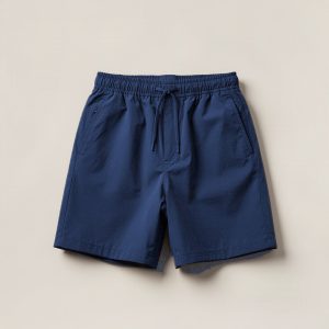 Ember Trail Short in Navy — lightweight trail shorts with an elastic drawcord waist, folded on a light grey backdrop