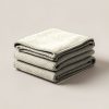 Ember Wool Blanket in Cream — thick woven wool blanket with stitched edges, folded on a light grey backdrop