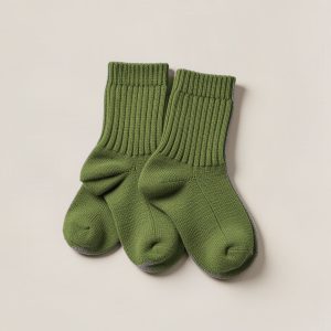 Granite Camp Sock in Moss — pair of thick ribbed camp socks on a light grey backdrop