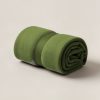 Granite Camp Throw in Moss — soft camp throw blanket, rolled with a strap on a light grey backdrop