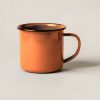Granite Enamel Mug in Rust — enamel camp mug with a rolled rim and a C-shaped handle on a light grey backdrop