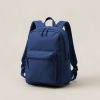 Harbor Daypack in Navy — zip-top daypack with padded shoulder straps and a front pocket on a light grey backdrop