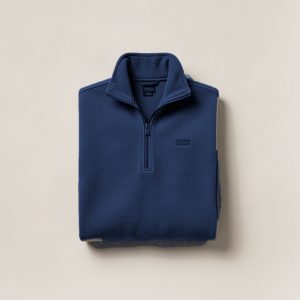 Harbor Fleece Pullover in Navy — quarter-zip fleece pullover, folded on a light grey backdrop