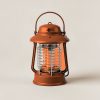 Harbor Lantern in Rust — camp lantern with a domed top, carry handle and ribbed diffuser on a light grey backdrop