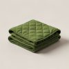 Harbor Quilted Throw in Moss — quilted throw with diamond stitching, folded on a light grey backdrop