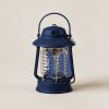 Juniper Lantern in Navy — camp lantern with a domed top, carry handle and ribbed diffuser on a light grey backdrop