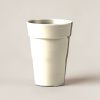 Juniper Pint Cup in Cream — stackable pint cup with a flared rim on a light grey backdrop