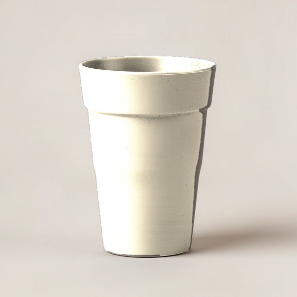 Juniper Pint Cup in Cream — stackable pint cup with a flared rim on a light grey backdrop