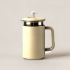 Juniper Travel Press in Sand — travel coffee press mug with a plunger lid and a handle on a light grey backdrop