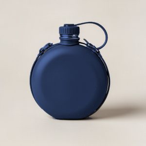 Lakeside Canteen in Navy — round flat-sided canteen with a screw cap and a carry strap on a light grey backdrop