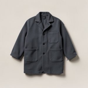 Lakeside Chore Coat in Charcoal — boxy button-front chore coat with two patch pockets on a light grey backdrop
