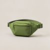 Ridgeline Hip Pack in Moss — compact hip pack with a zipped front pocket and a buckled waist strap on a light grey backdrop
