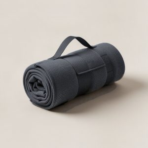Ridgeline Stadium Blanket in Charcoal — compact stadium blanket, rolled with a carry strap on a light grey backdrop