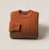 Summit Watch Sweater in Rust — chunky ribbed-knit crew-neck sweater, folded on a light grey backdrop