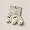 Tamarack Camp Sock in Cream — pair of thick ribbed camp socks on a light grey backdrop