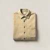 Tamarack Flannel Shirt in Sand — button-up flannel shirt, folded on a light grey backdrop