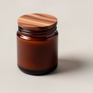 Trailhead Soy Candle — soy candle in an amber glass jar with a wooden lid on a light grey backdrop