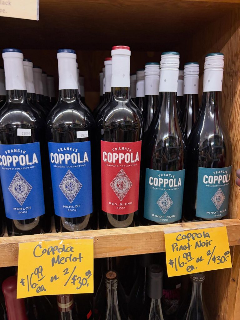 Coppola wines on the shelf with handwritten price tags