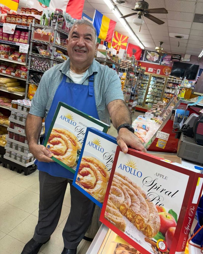Mike's team member holding boxes of Apollo spiral pies in the grocery aisle