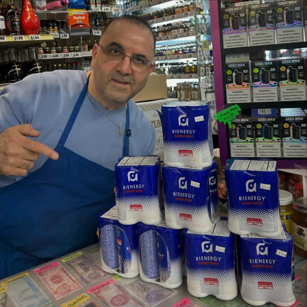 Mike's team member behind the counter next to a stack of energy drinks