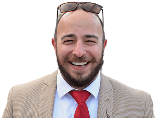 Mousa Batarseh smiling in a suit