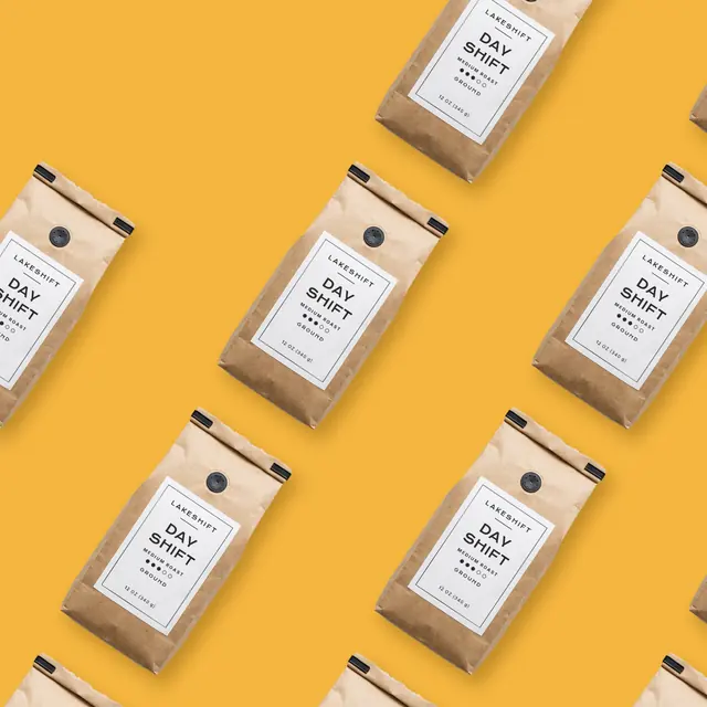 Rows of Lakeshift Day Shift coffee bags laid out diagonally on a yellow ground, every label the same.